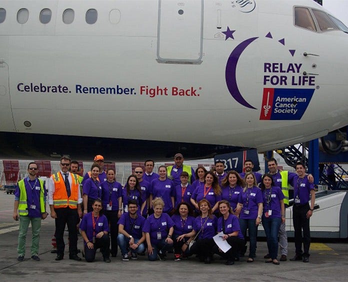 Delta Day of Hope team members in front of Delta Relay For Life airplane
