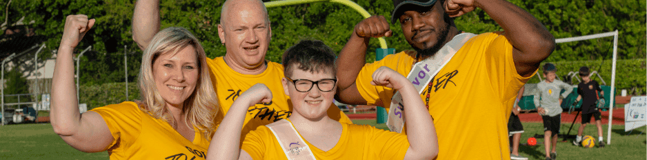 group of people all wearing gold shirts while flexing muscles at a Gold Together event