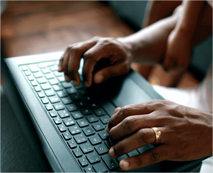 black male hands typing on keyboard