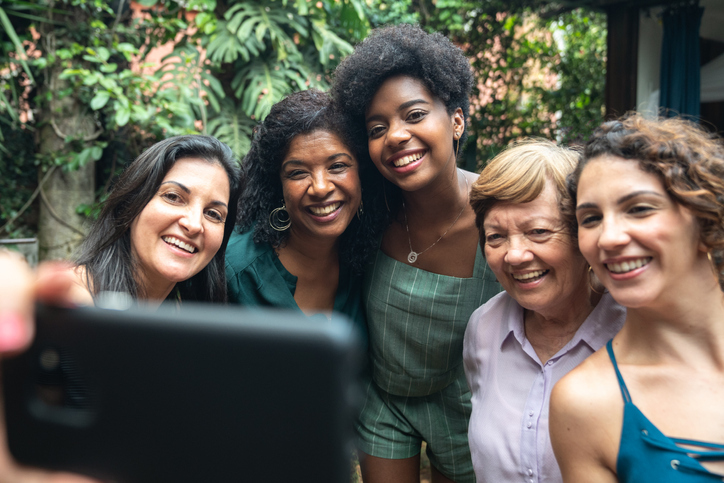 Group of Black and White women taking selfie