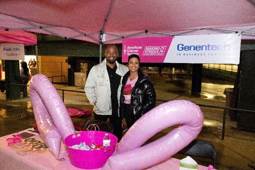 Black couple standing under a tent at a Strides event