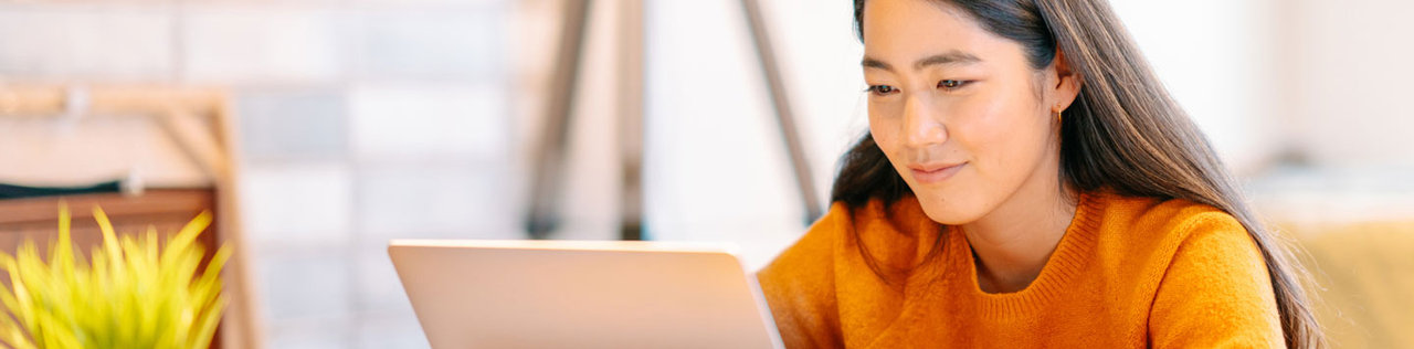 Woman using a laptop while sitting indoors