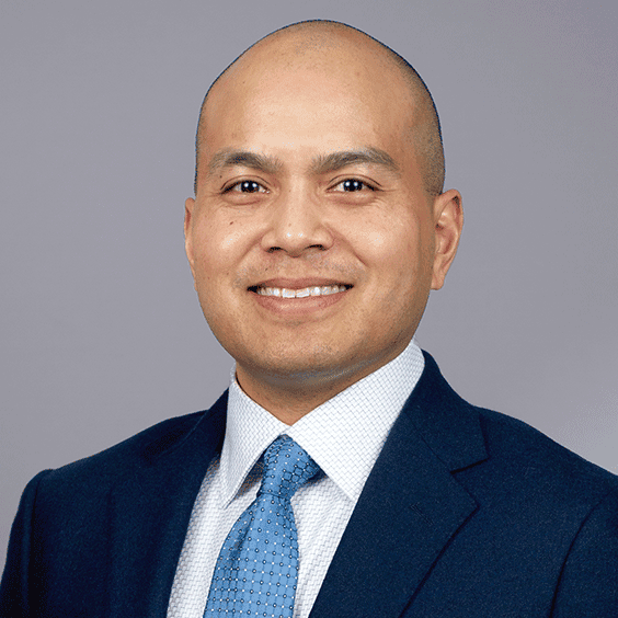 Smiling man in suit and blue tie portrait