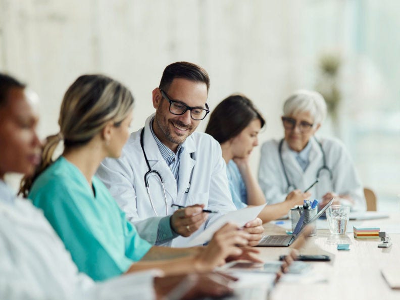 Five doctors at a conference table