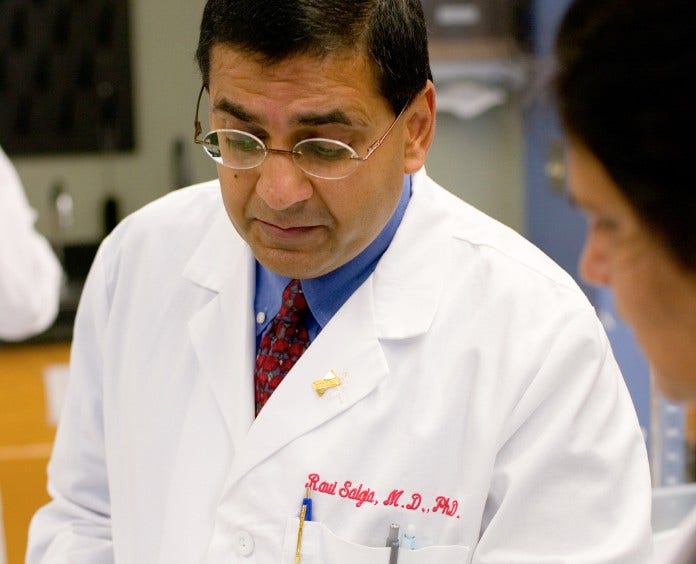 male doctor assisting students in a lab