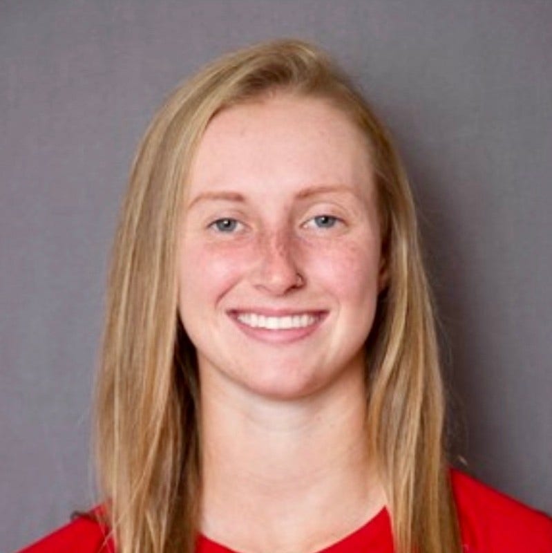 Young white woman, long strawberry blonde hair, freckles, red top