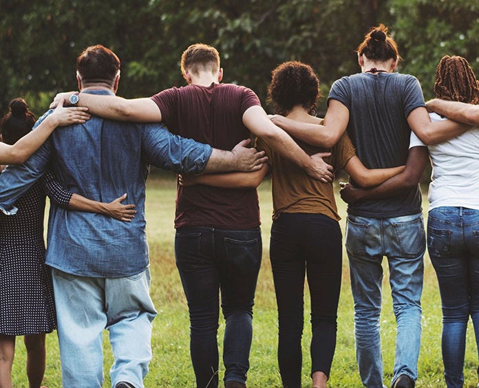 group of young adults hugging in a line