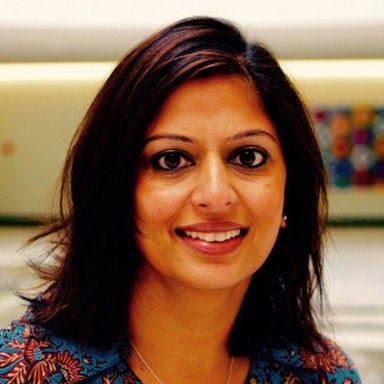 asian woman wearing turquoise patterned shirt 