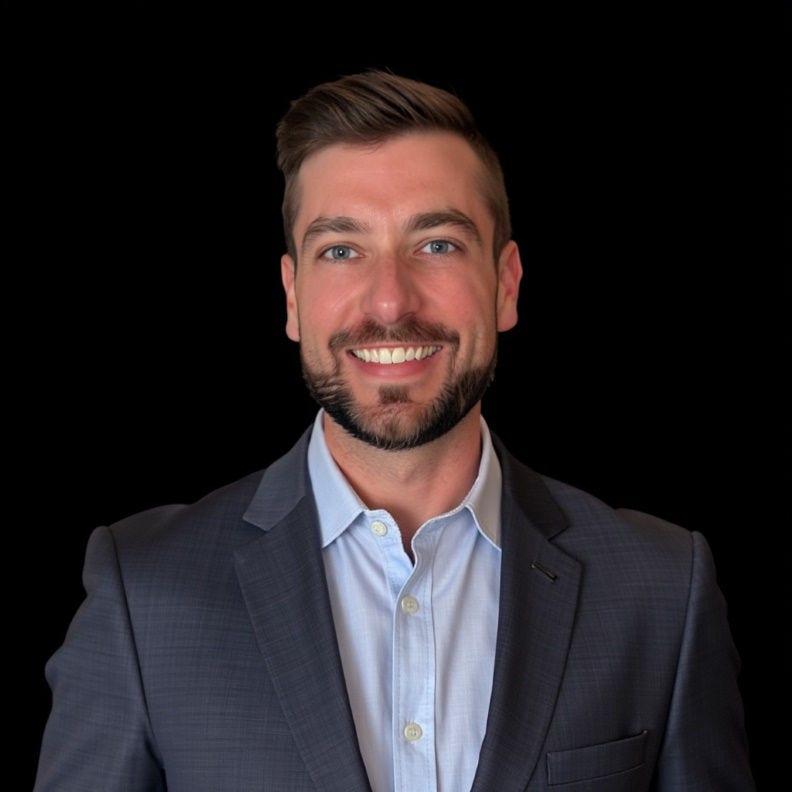Smiling man in suit jacket, professional headshot.