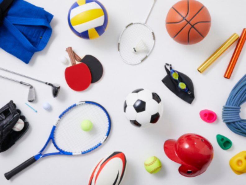 Assorted sports equipment on white background, neatly arranged.