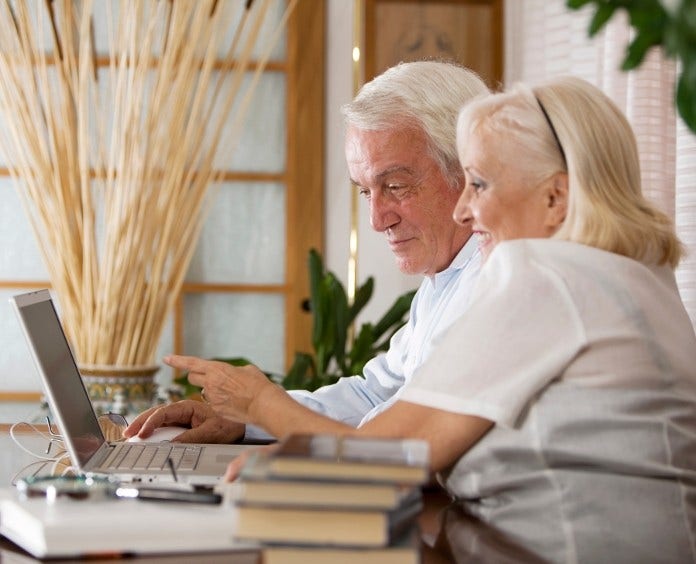 senior couple working on laptop computer