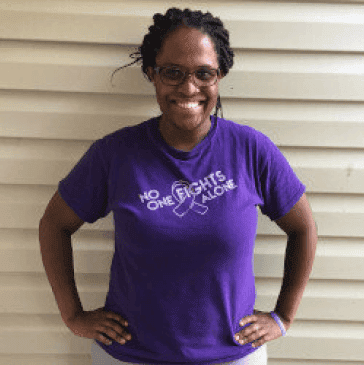 black woman with braids wearing glasses and purple shirt