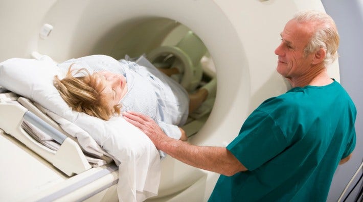 male doctor with female patient during a ct scan