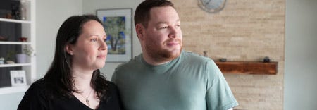 Two cancer survivors look into the distance as they reflect on their journey as cancer survivors