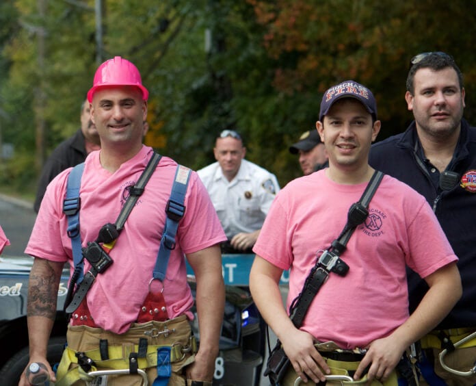 group of firefighters wearing pink shirts
