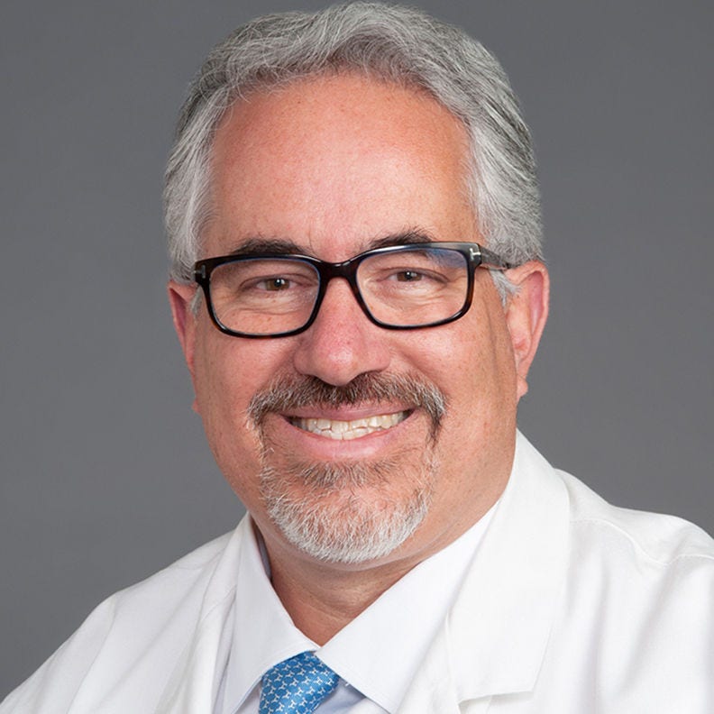 Portrait of Ruben A. Mesa, MD, FACP with a grey background