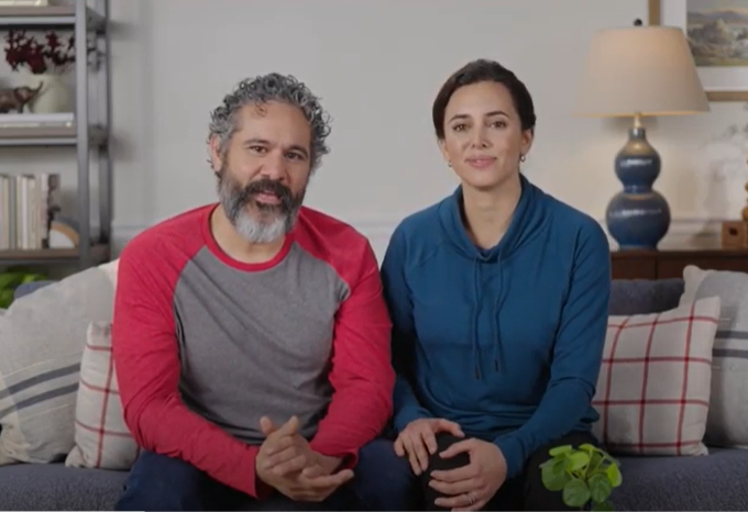 Video still showing a couple sitting on a couch