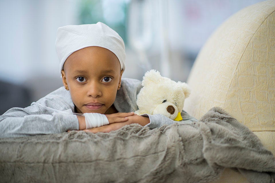 Black child with white headwrap and white bear