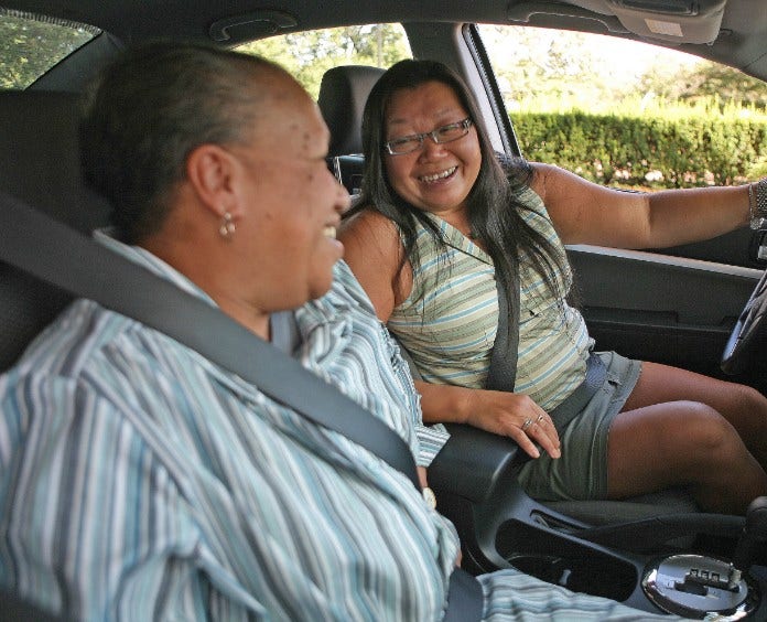 asian woman and black woman riding in car