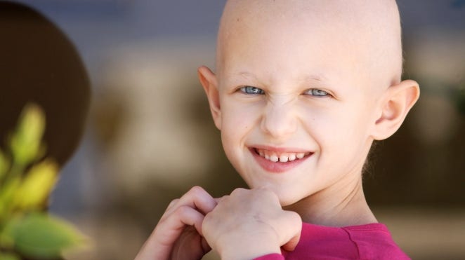 smiling childhood cancer patient