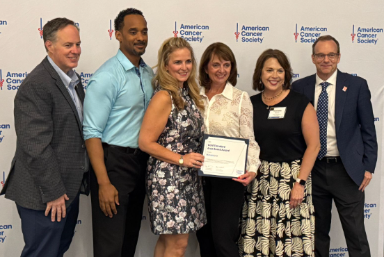 Volunteer award winners and staff posing with award