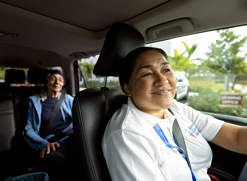 Volunteer driver in car with passenger