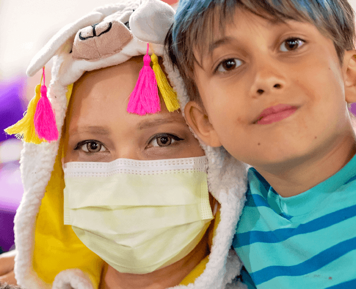 Close up of Victoria wearing a mask and her son 