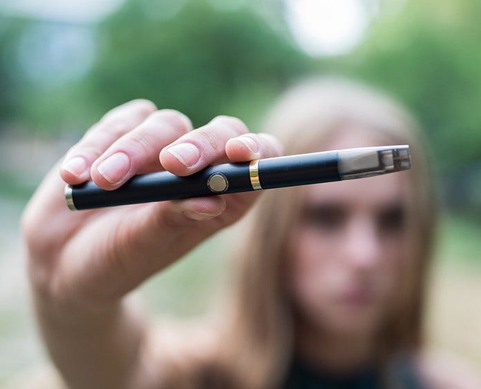 Woman smoking electronic cigarette outdoor