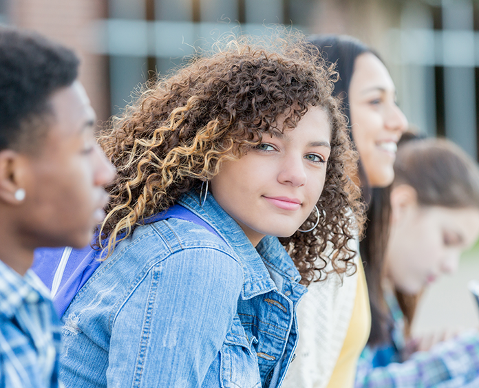 girl with long curly hair wearing jean jacket