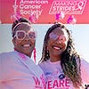 Two women wearing pink at a Making Strides Against Breast Cancer walk