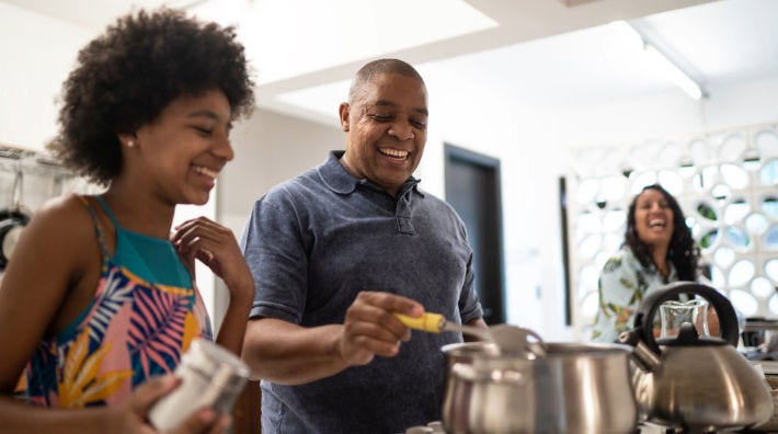 man in shorts doing reverse pushup at desk