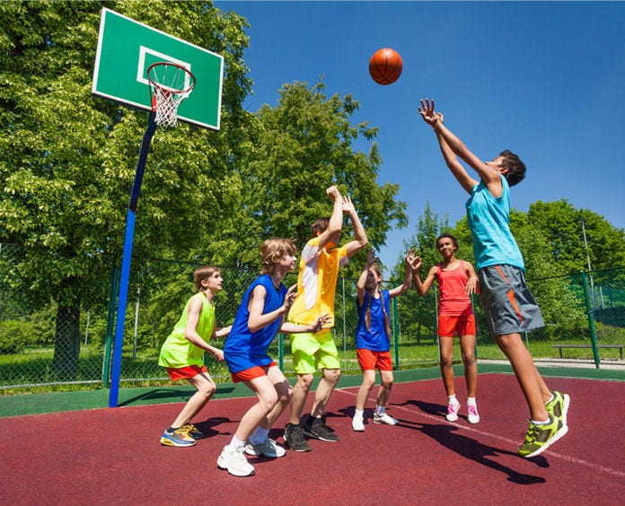group of kids playing basketball on court