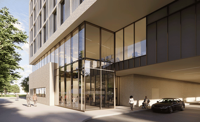 Glass corner entrance beneath elevated modern building with parked car.