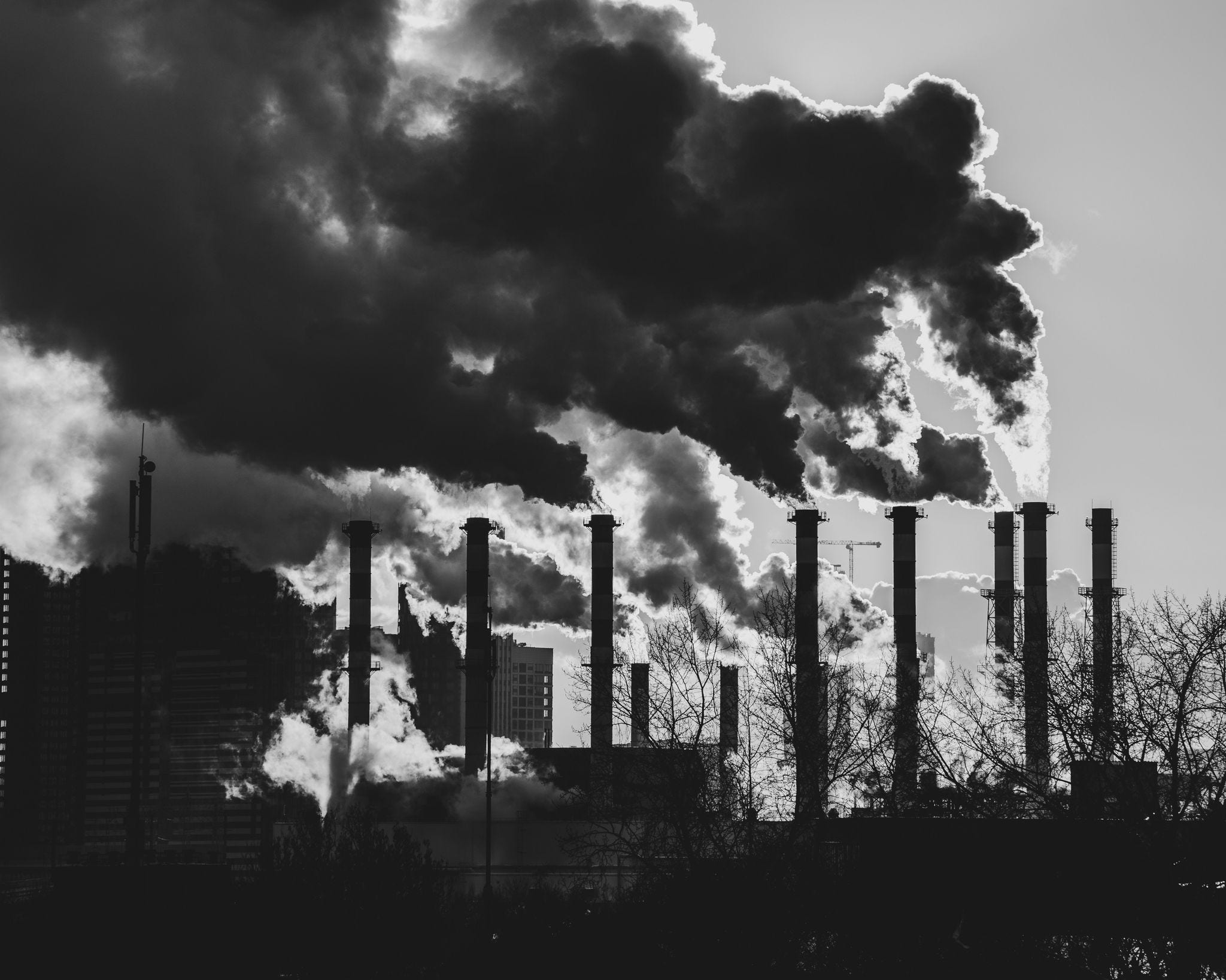 black and white black smoke in air from towers