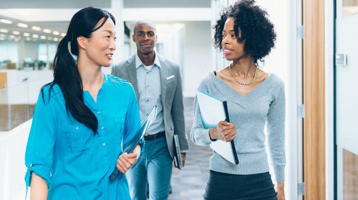 diverse group of office workers walking during meeting