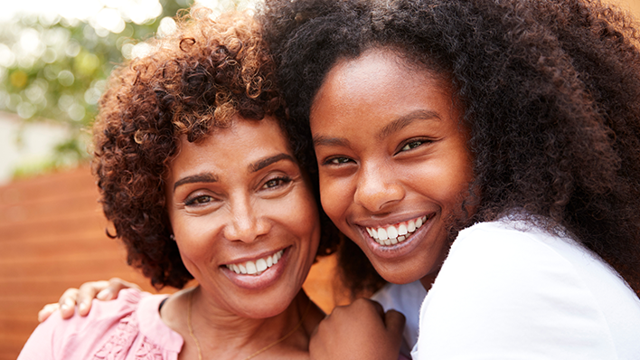 black mother and daughter smiling