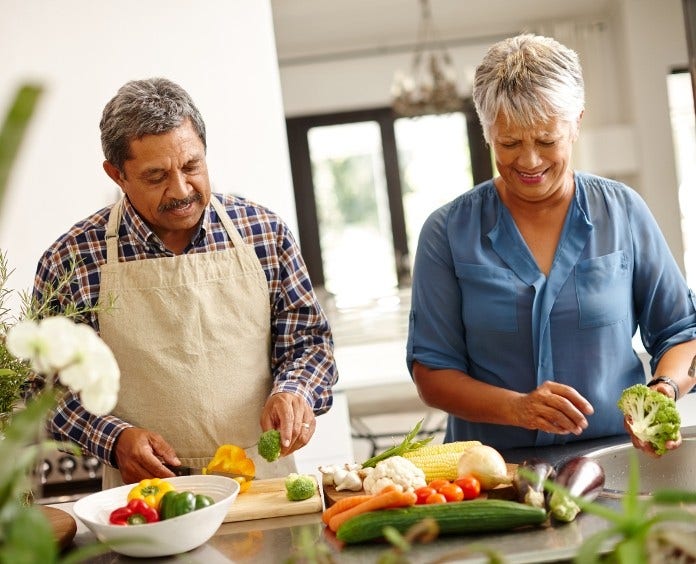 Man and woman chop vegetables