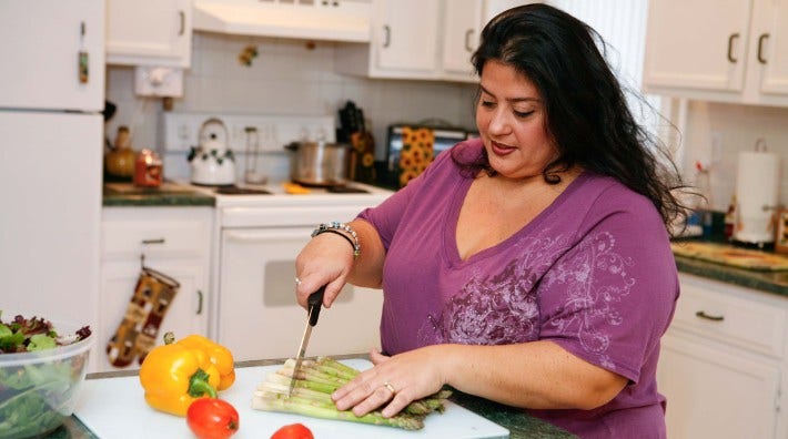 woman cutting vegetables in her kitchen