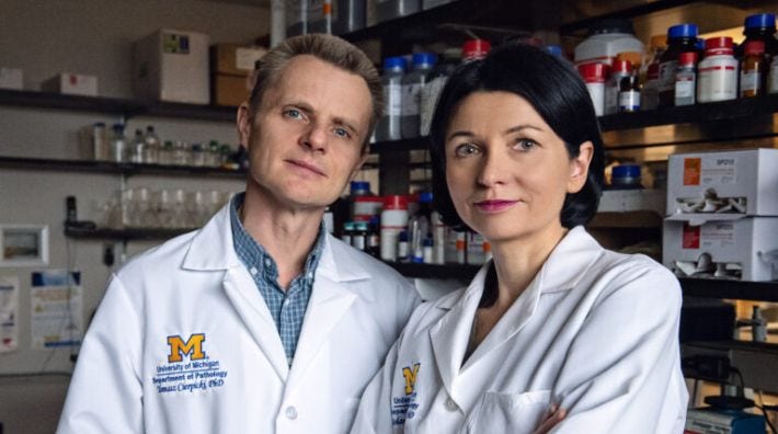 Two scientists in white lab coats 