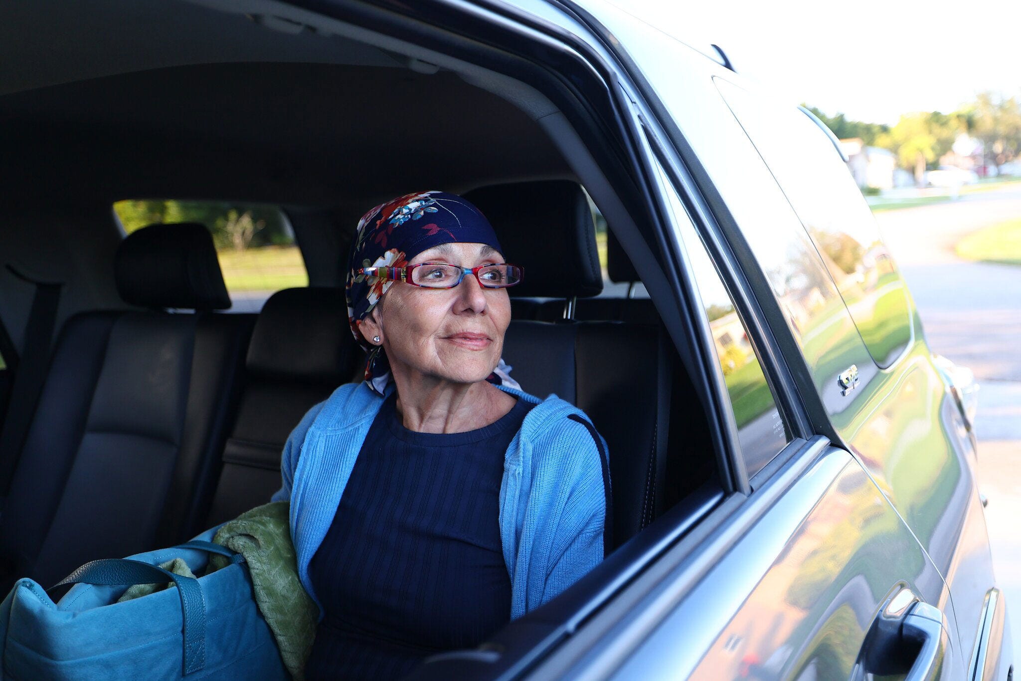 A cancer patient (graciela) sits in vehicle participating in the road to recovery program offered by the American Cancer Society