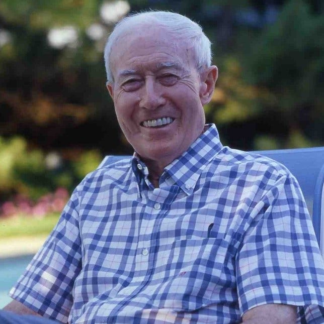 Jules L. Plangere, Jr. sitting in a lawn chair near a pool