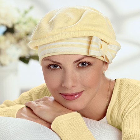 woman wearing a tlc hair loss product (hat)  