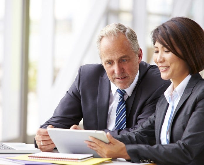 Two senior business colleagues at meeting, close-up