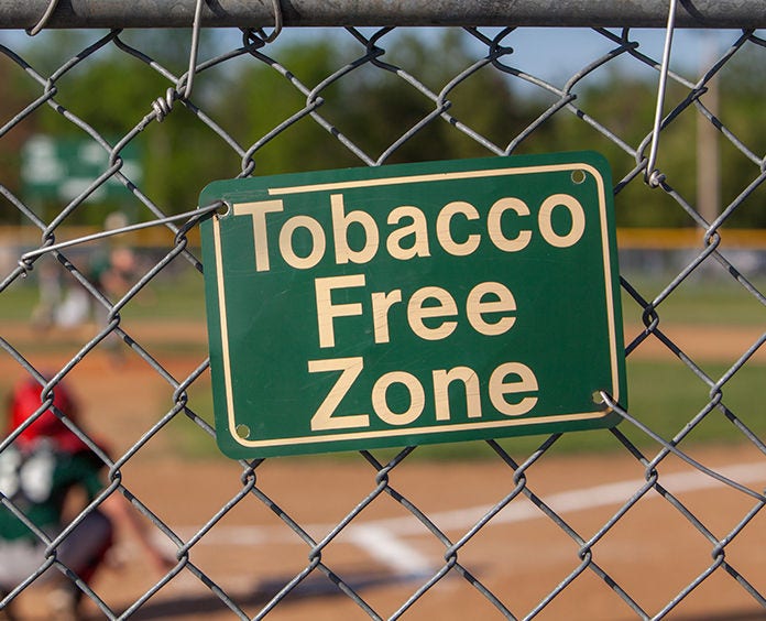 tobacco free zone sign on chain linked fence
