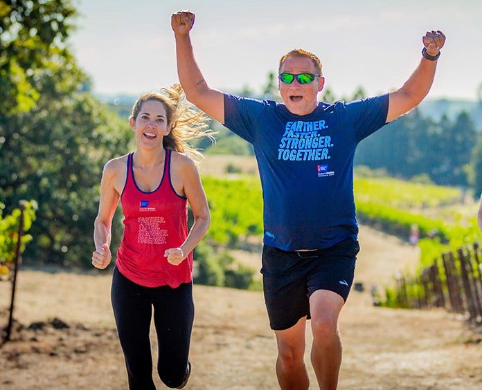 Two Determination participants running through vinyards