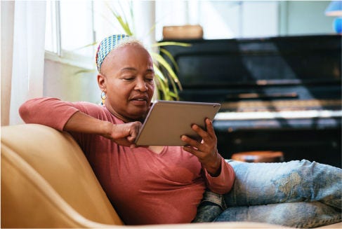A person using a tablet exploring patient support programs offered through the American Cancer Society and Color partnership
