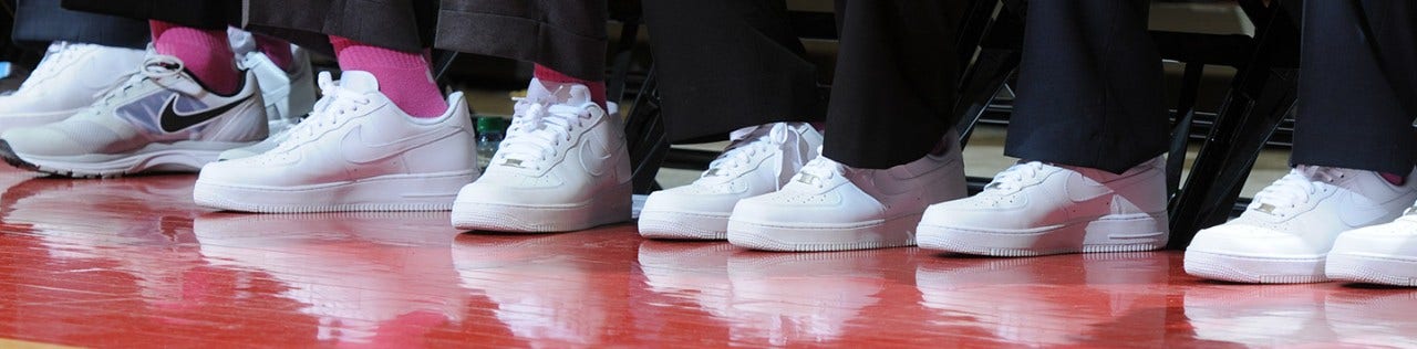 view of multiple shoes on the basketball court