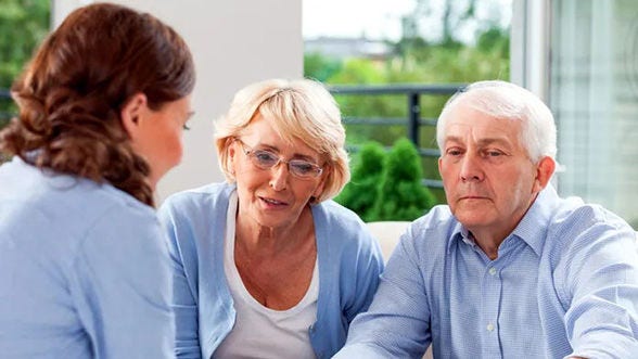 Older couple reviews document with woman
