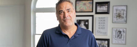 A male lung cancer survivor inside a room poses for image