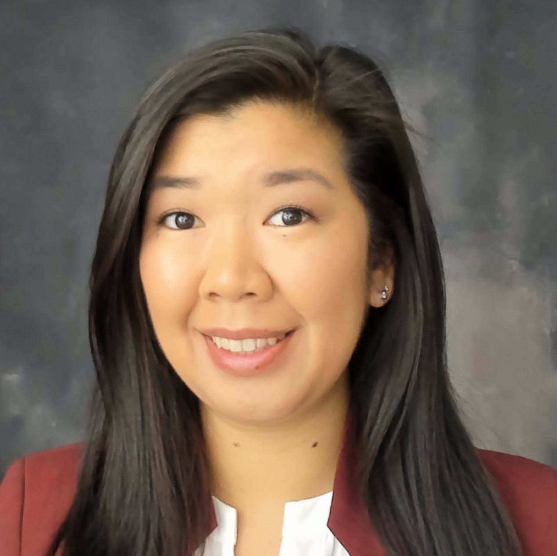 Headshot of Marisa Wong, MPH, in a red blazer over a white blouse